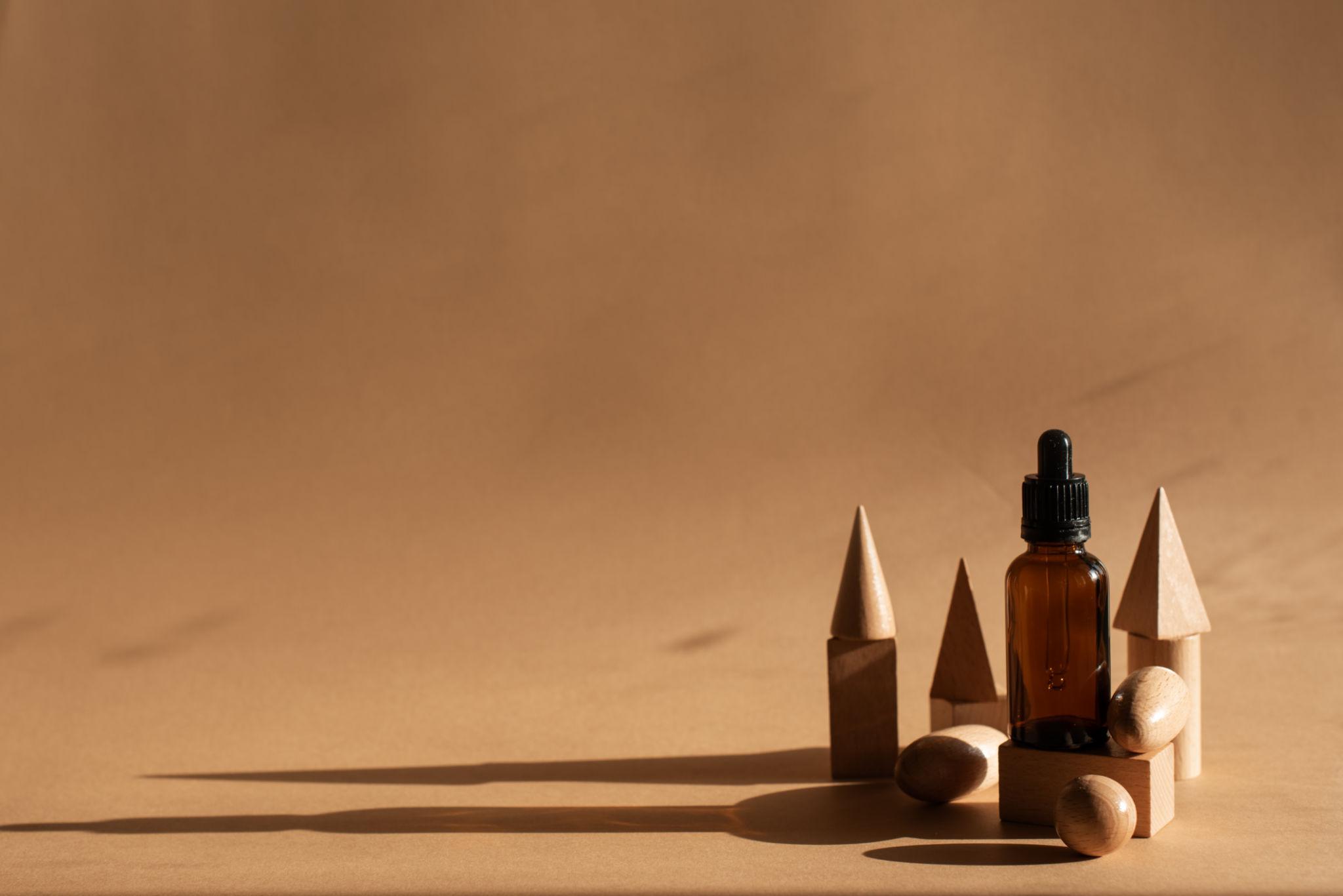 Minimal perfume materials and bottle in soft natural light representing clean, intentional fragrance formulation