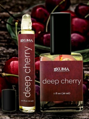 deep cherry perfume on a wooden table surrounded by fresh cherries